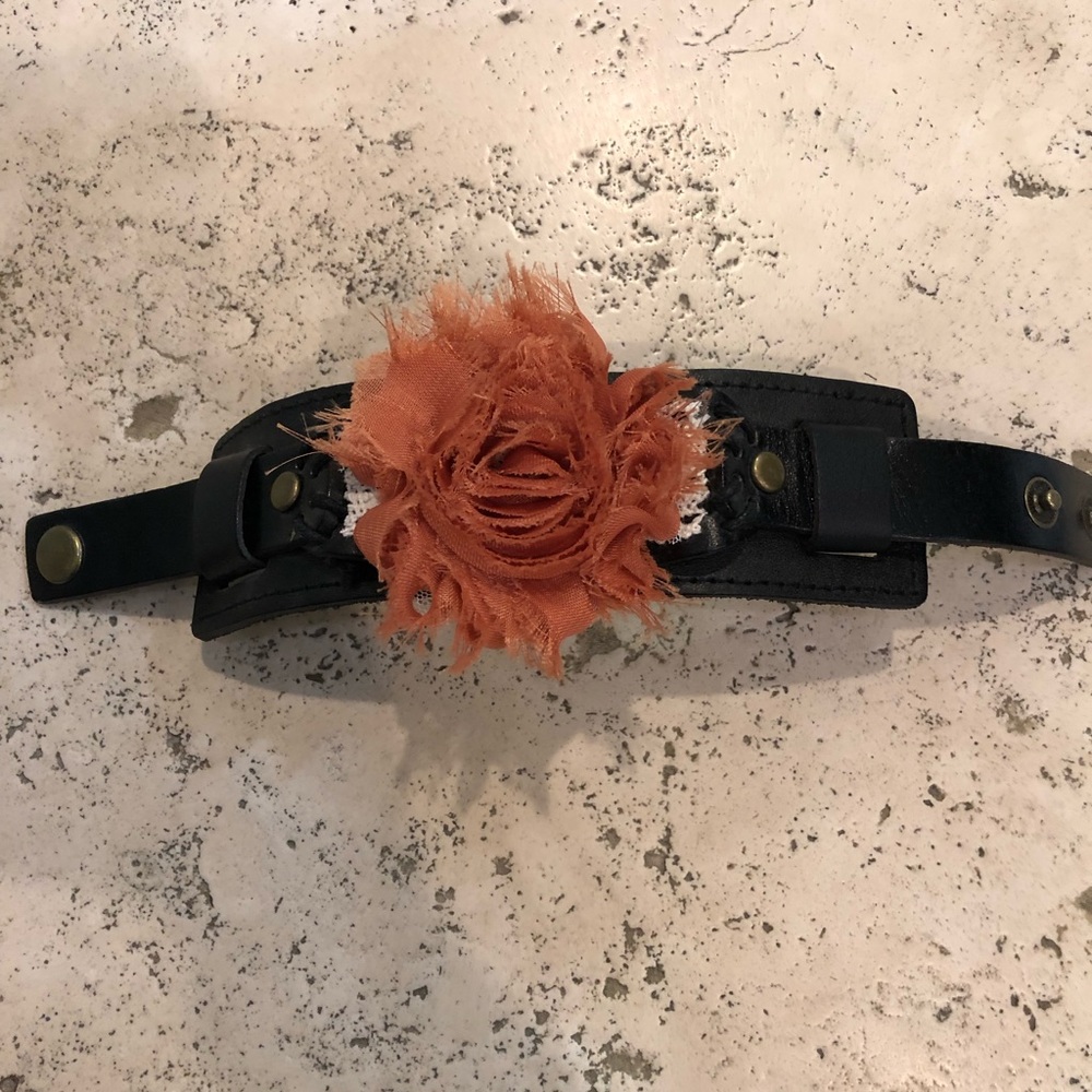 Leather adjustable cuff with orange boho flower.
